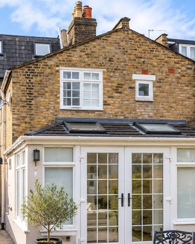 Victorian brick terrace with a new rear extension, roof lights and French doors onto the garden